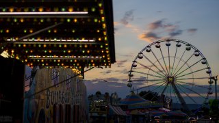 WASHINGTON, USA – SEPTEMBER 15: The sun sets over the amusement rides at The Great Frederick Fair in Frederick, Md., United States on September 15, 2017. (Photo by Samuel Corum/Anadolu Agency/Getty Images)